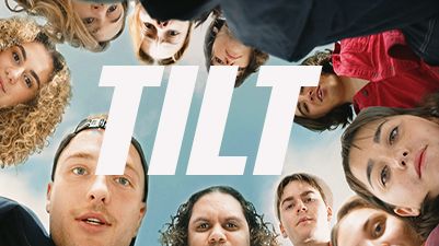 Photo of a circle of students' heads looking down towards camera with the word Tilt in large white block letters in centre