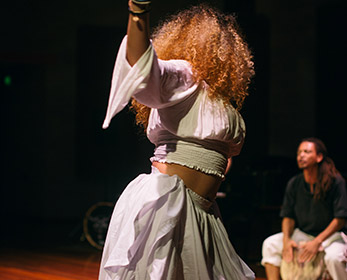 Female dancer and male drummer performing on stage