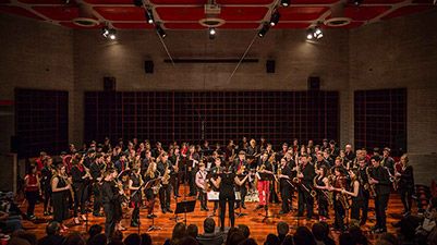 Group of young saxophone players performing live on stage